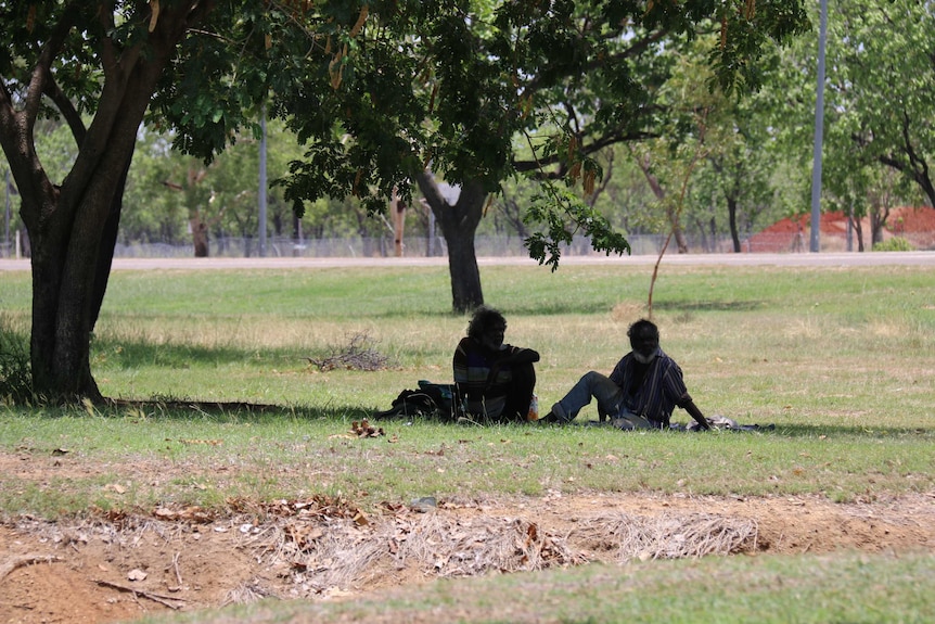 Men sitting on the grass in Katherine