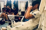 Ben Stokes pulls his hat over his face after winning the third Test.
