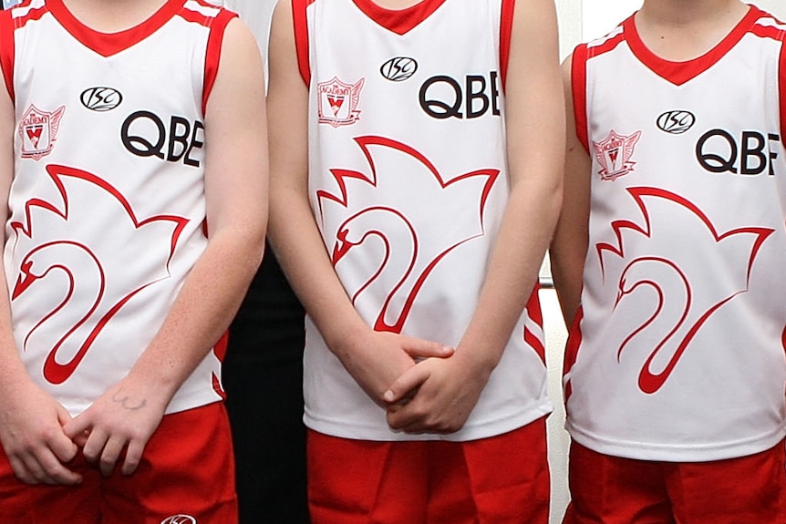 A tightly cropped image of unidentified Sydney Swans academy junior players in their guernseys.