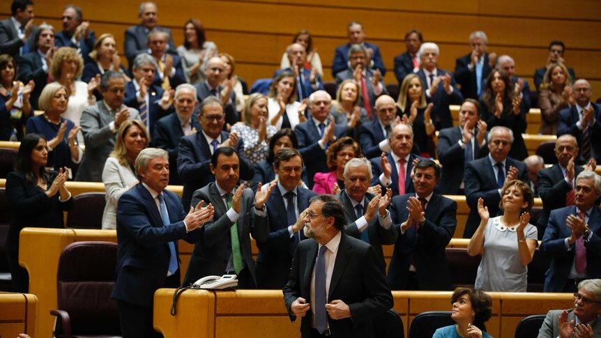 Spain's Prime Minister Mariano Rajoy, centre, is applauded in the Spanish Senate.