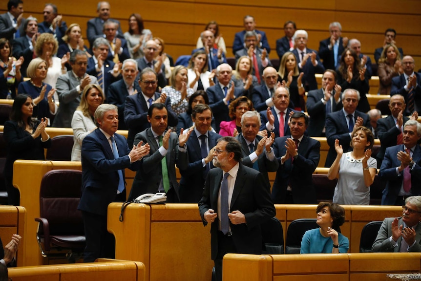 Spain's Prime Minister Mariano Rajoy, centre, is applauded in the Spanish Senate.