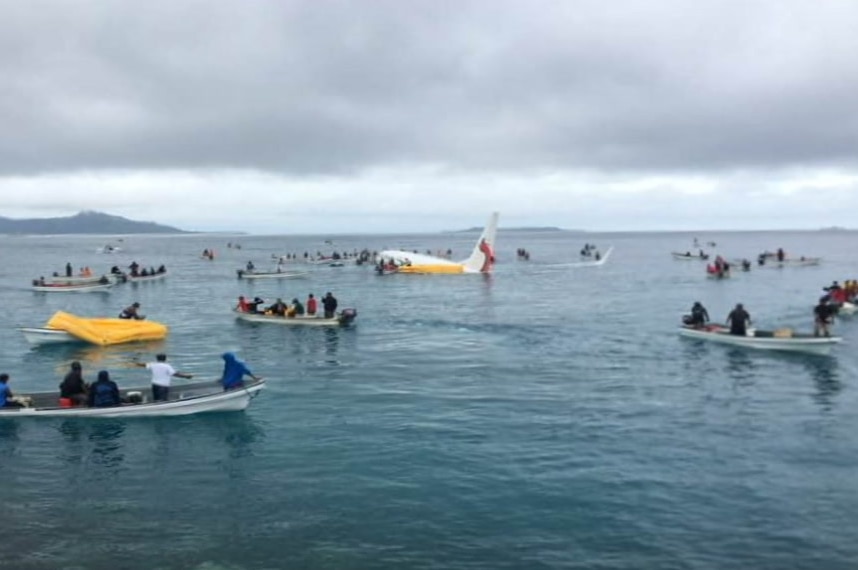 Fishing boats surround plane