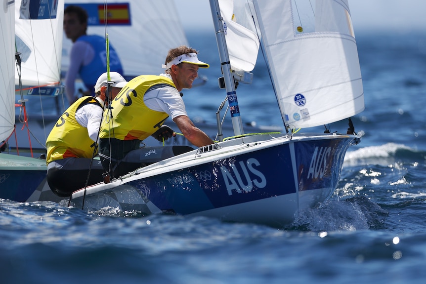 Two Australian sailors sit side by side as they race in the Olympics.