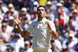Mitchell Starc grimaces at a half-chance gone begging as a fielder in the foreground dives in vain for a catch