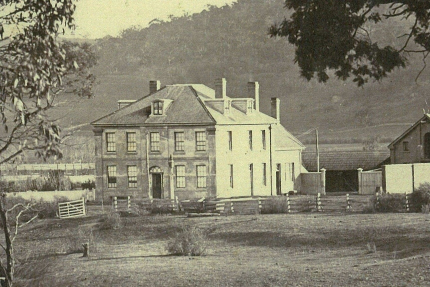 The Melton Mowbray hotel in the 1800's with the sand stone water trough visible behind the fence at the front right-hand corner of the building.
