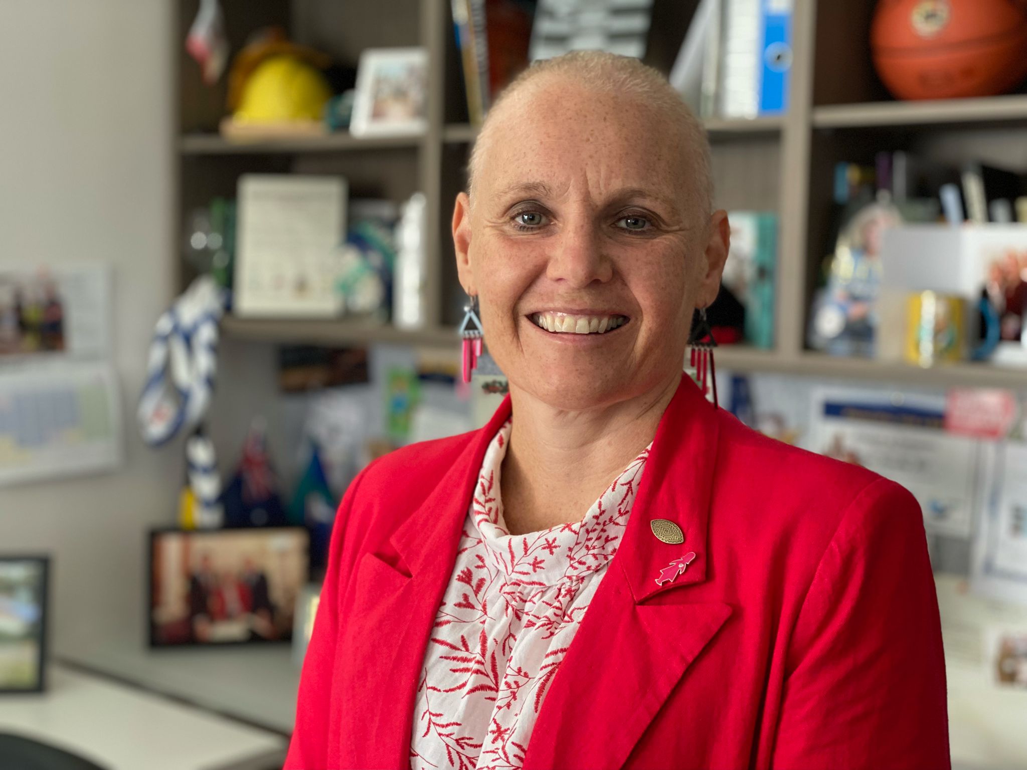 Peta Murphy smiles while standing in her electorate office