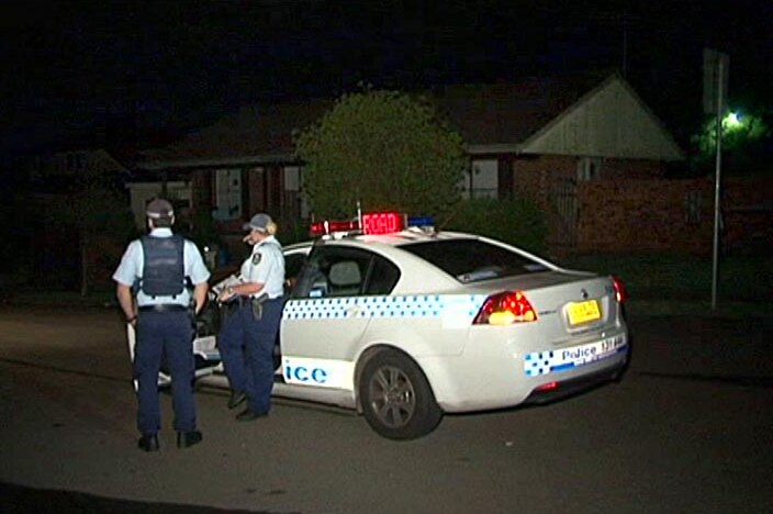 Police at the scene where four shots were fired into a home on Coleridge Street at Wetherill Park.