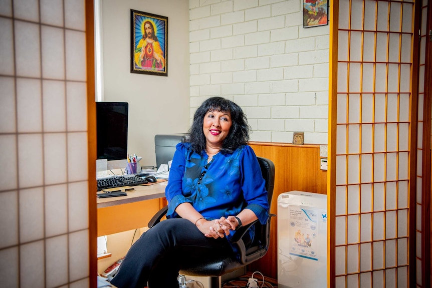 A woman pictures in her office