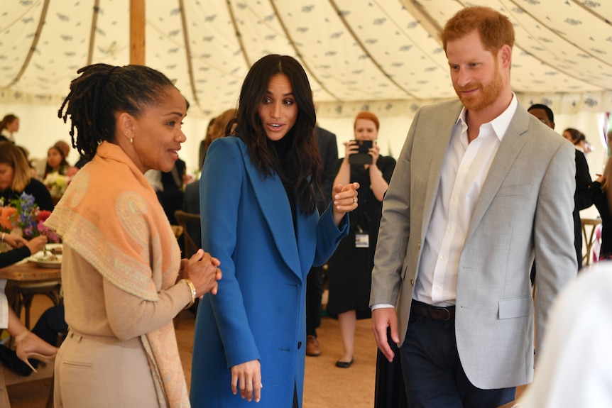 Meghan Markle (centre), her mother, Doria Ragland (left) and Britain's Prince Harry.