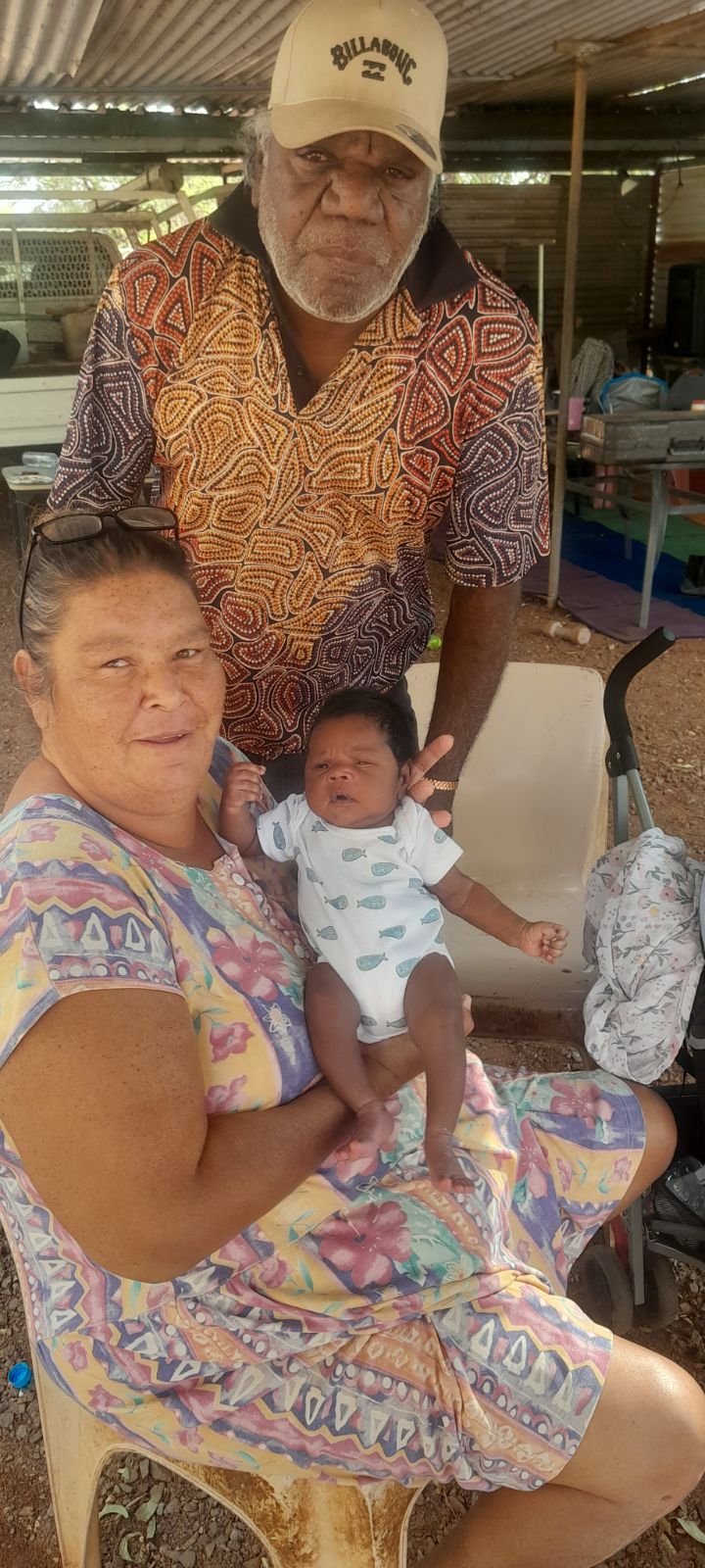 an aboriginal couple with a little baby