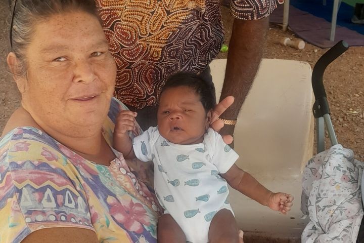 an aboriginal couple with a little baby