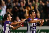 Liam Miller and Travis Dodd celebrate a goal for Perth Glory against the Newcastle Jets.