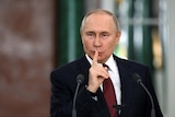 Russian President Vladimir Putin speaks during a news conference.