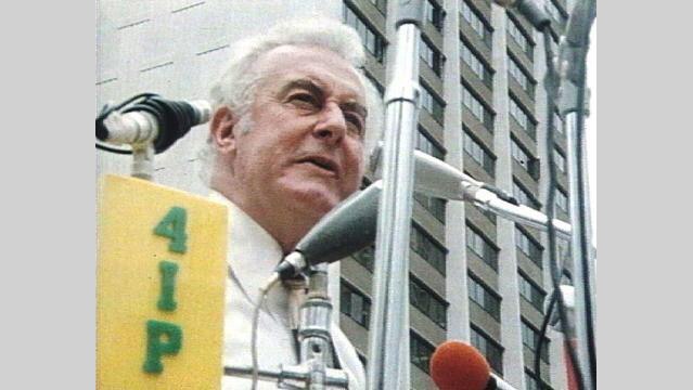 Gough Whitlam stands at microphone