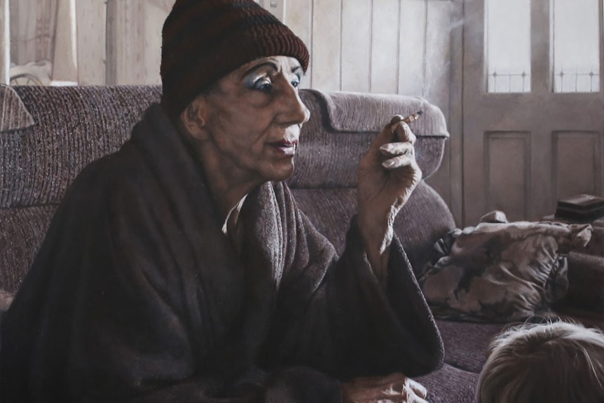 A portrait of a man sitting in his lounge room smoking and wearing a beanie. The work is titled Just an Old Drag Queen.