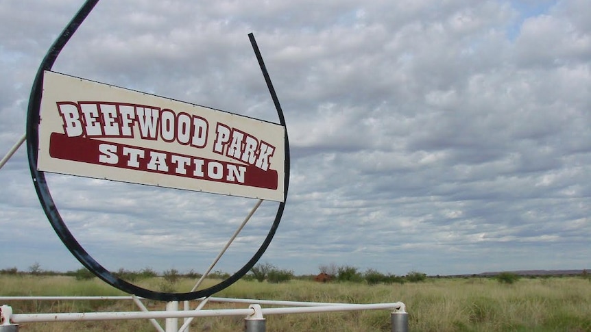 A sign outside Beefwood Park Station, held up by a giant horseshoe shape.