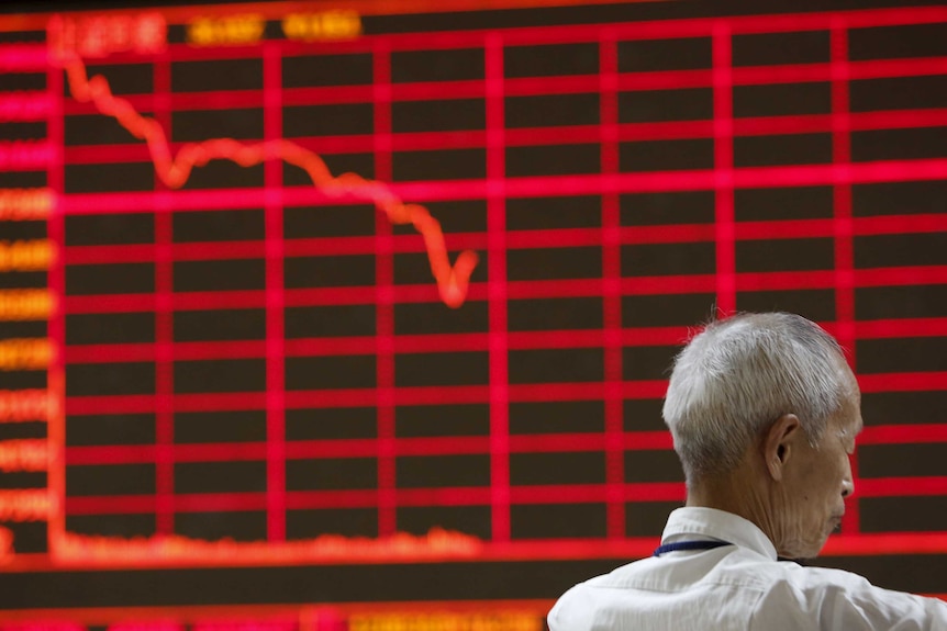 Man in front of electronic board