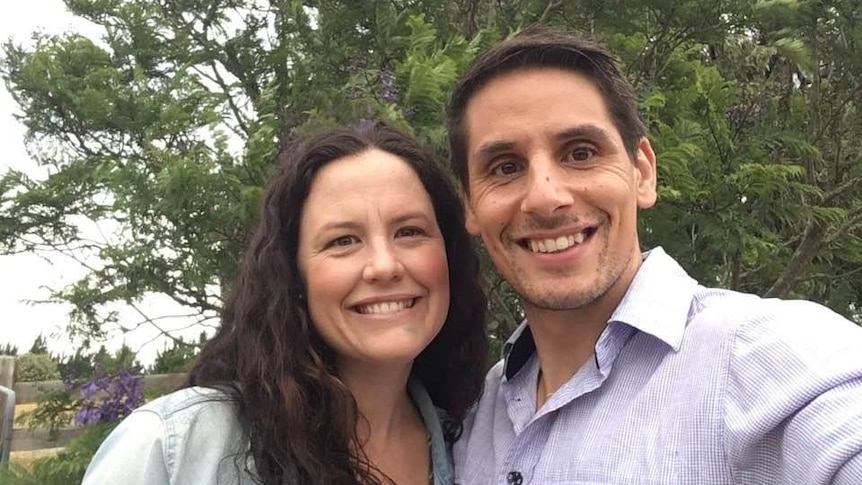 A smiling man and woman take a selfie