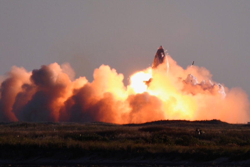 A rocket explodes in a fireball.
