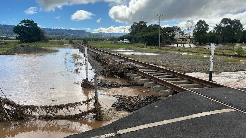 A rail line with the soil washed out from under it.