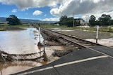 A rail line with the soil washed out from under it.