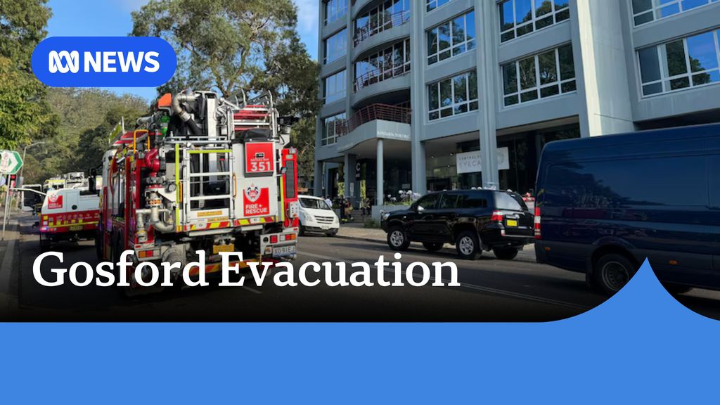 Gosford Evacuation: A fire engine on a street outside an office building.