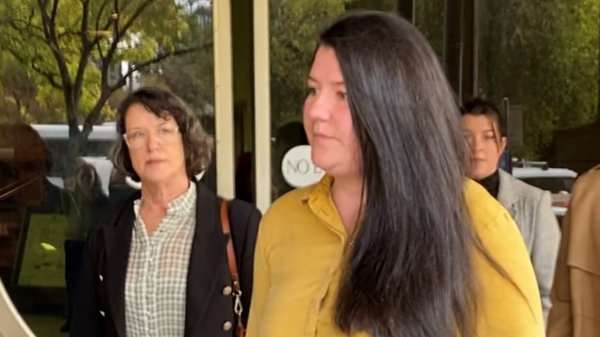 A woman walks outside Adelaide's District Court