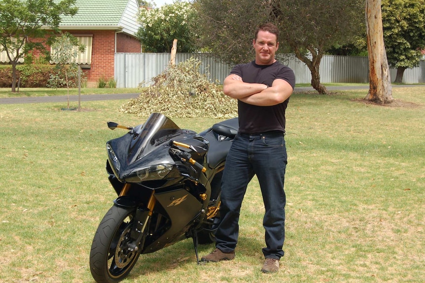 Darren Wilson next to his motorbike