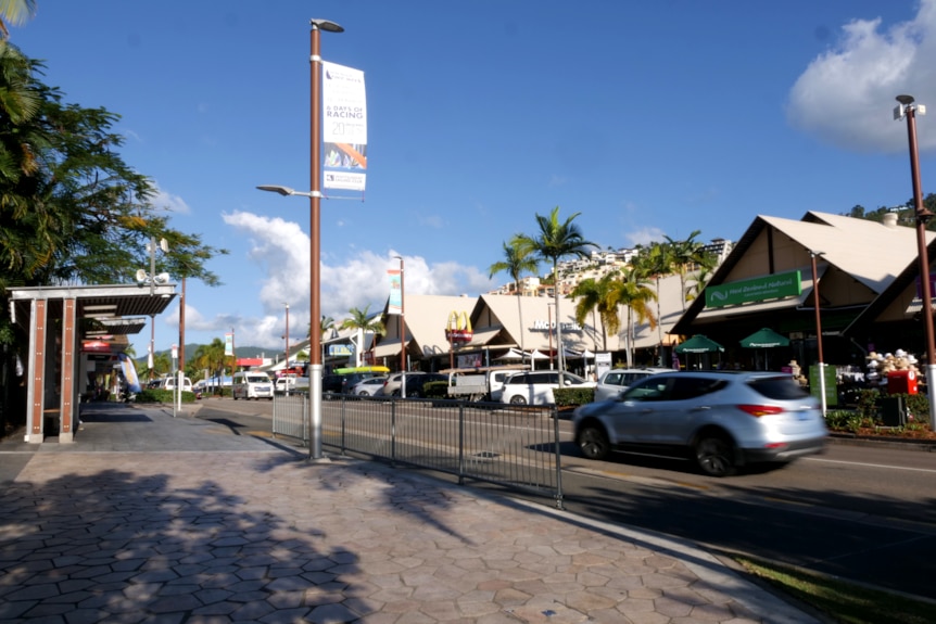 A tropical town beneath a deep blue sky.