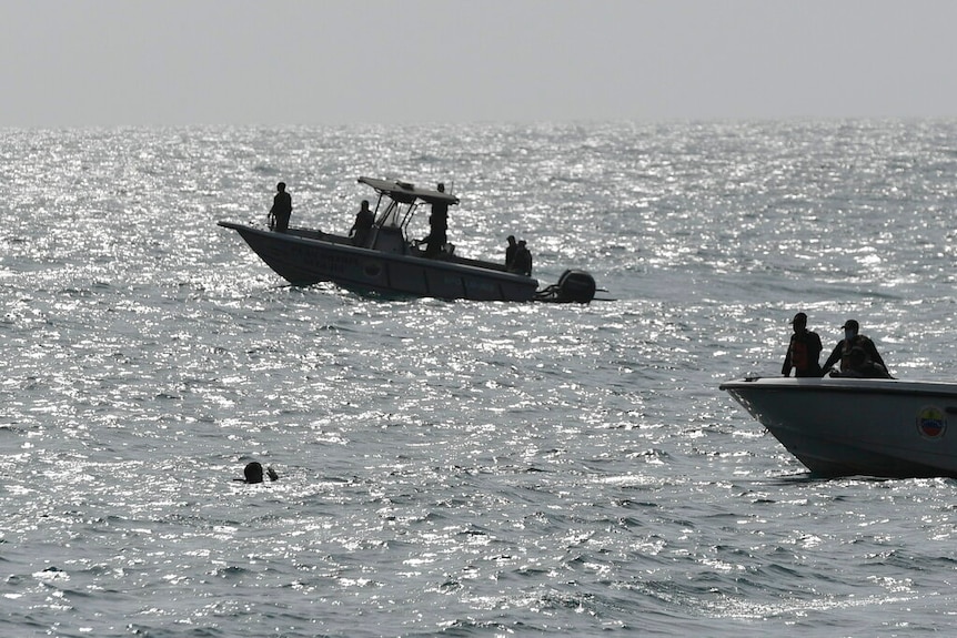 Security forces investigate near the shore in the port city of La Guaira, Venezuela.