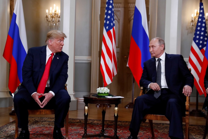 US President Donald Trump meets with Russia's President Vladimir Putin in a formal room in the presidential palace