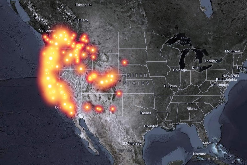 A map of the west coast of the United States with many glowing dots symbolising fires.