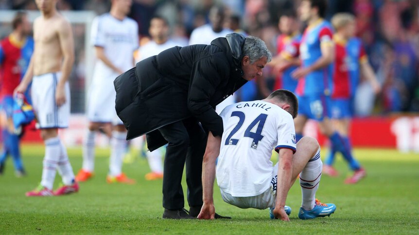 Upset result ... Jose Mourinho consoles the dejected Gary Cahill following Chelsea's loss