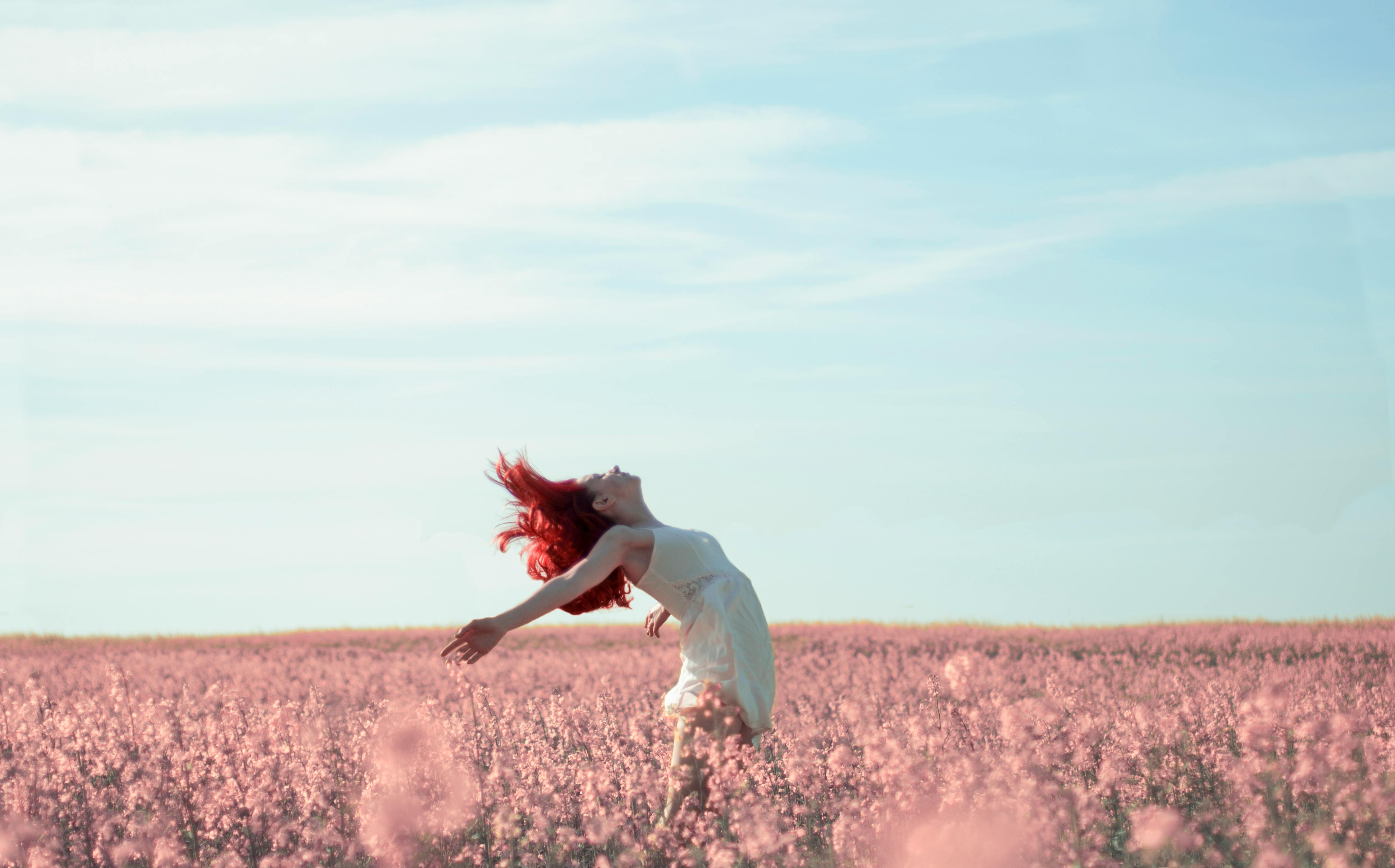Woman in Yellow Dress Standing on Pink Petaled Flower Field