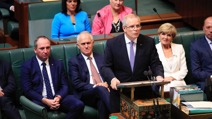 Prime Minister Malcolm Turbnull sits behind Treasurer Scott Morrison grimacing during the 2017 federal budget.