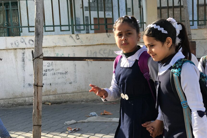 School girls walk down the street in gaza before the war 
