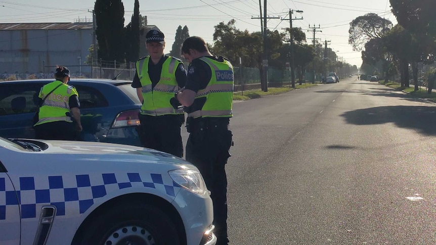 Police at the scene of a stand-off in Altona North