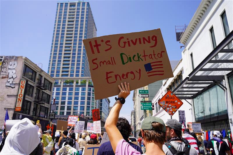 Protesters hold signs in the streets of Los Angeles' downtown area.