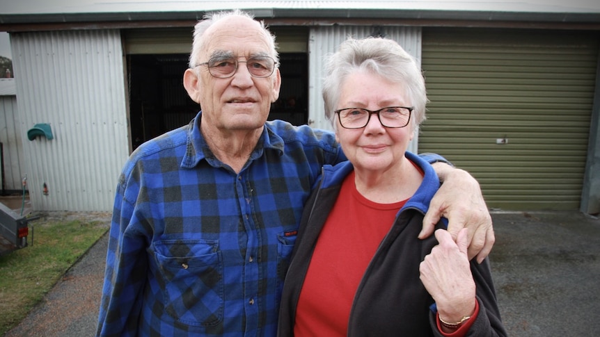 Harold and Barbara Cronin stand outside their new home