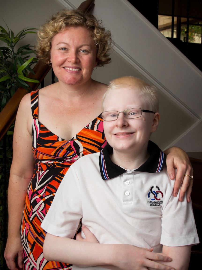 Kirsty Russell stands next to her son Xander.