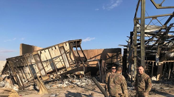 US soldiers standing at the site where an Iranian missile hit in Iraq