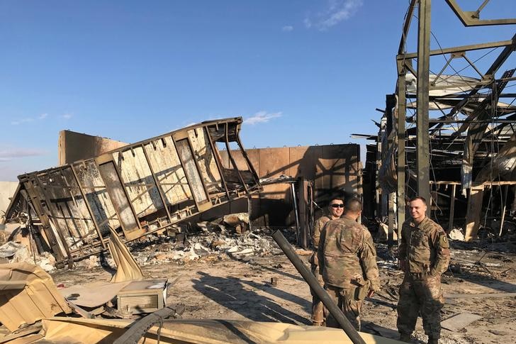 US soldiers standing at the site where an Iranian missile hit in Iraq
