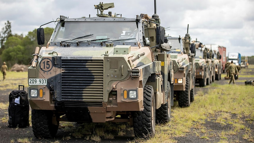 A long line of armoured military vehicles.