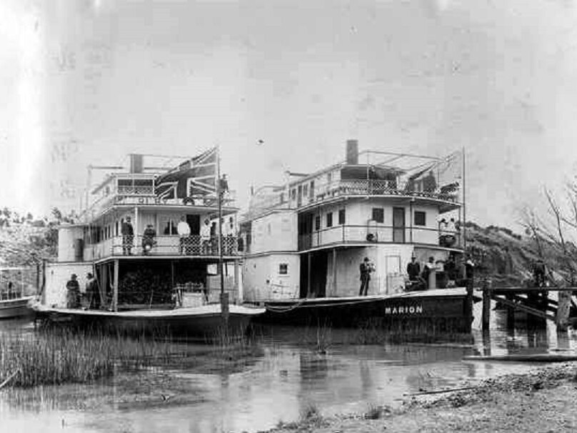 two paddle steamers side-by-side on the river, black and white photo