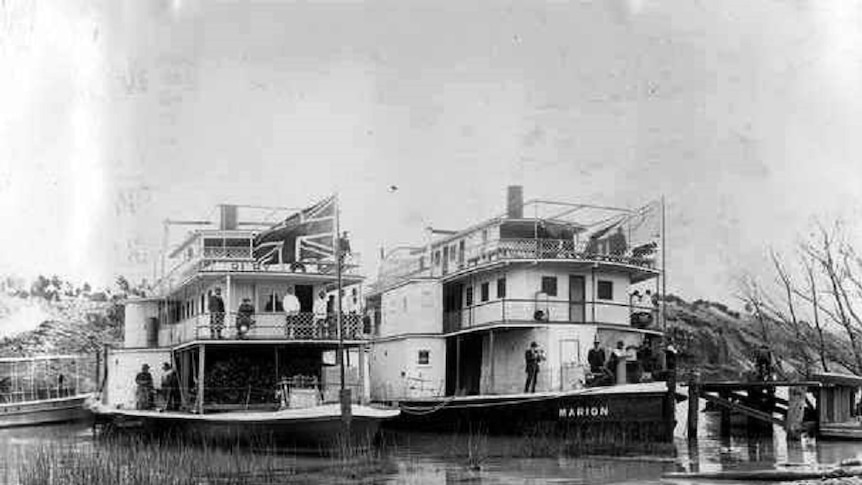 two paddle steamers side-by-side on the river, black and white photo
