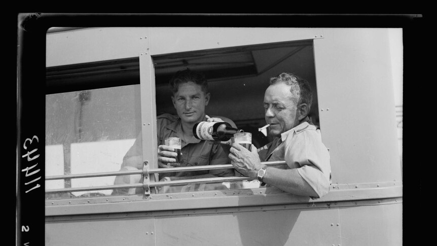 Soldiers enjoying a refreshing beverage at the Beersheba racing meet in May, 1940.