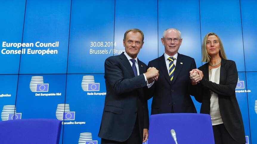 Newly elected European Council President Donald Tusk (L) of Poland and newly elected European High Representative for Foreign Affairs Federica Mogherini (R) of Italy are congratulated by outgoing European Council President Herman Van Rompuy.