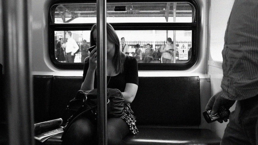 Woman on a train looking at her smartphone