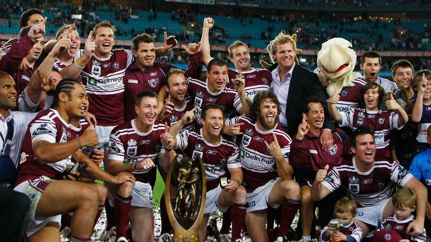 Manly Sea Eagles players celebrate with the trophy after winning the NRL grand final