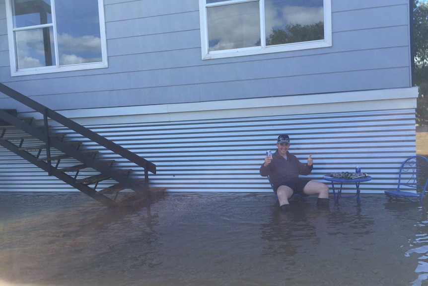 Jesse Hamilton outside his flooded house